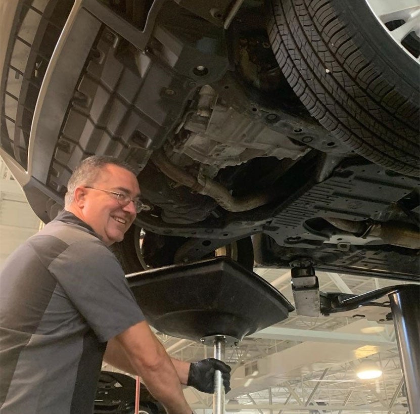 Service Tech performing oil change